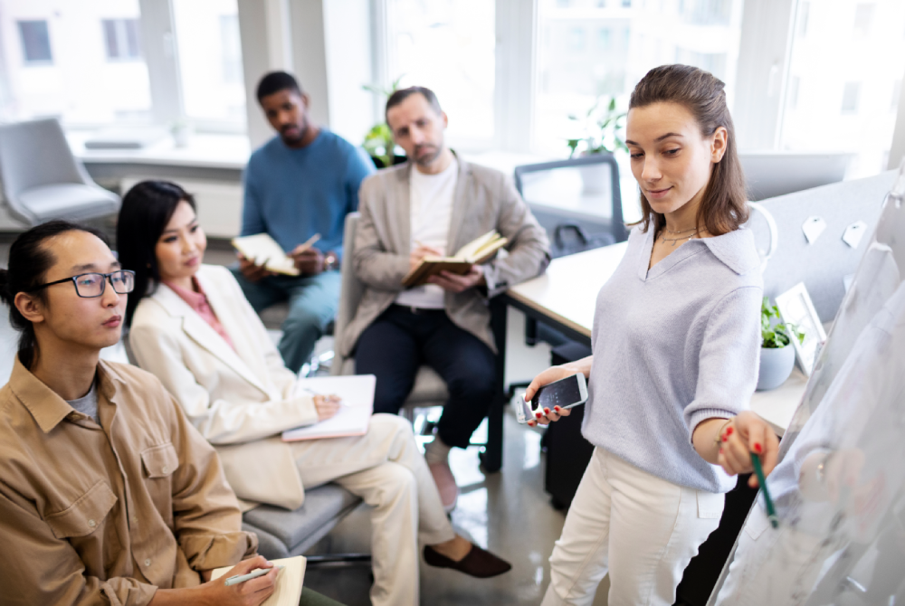 Team of professionals brainstorming event logistics during a meeting in a modern office setting.